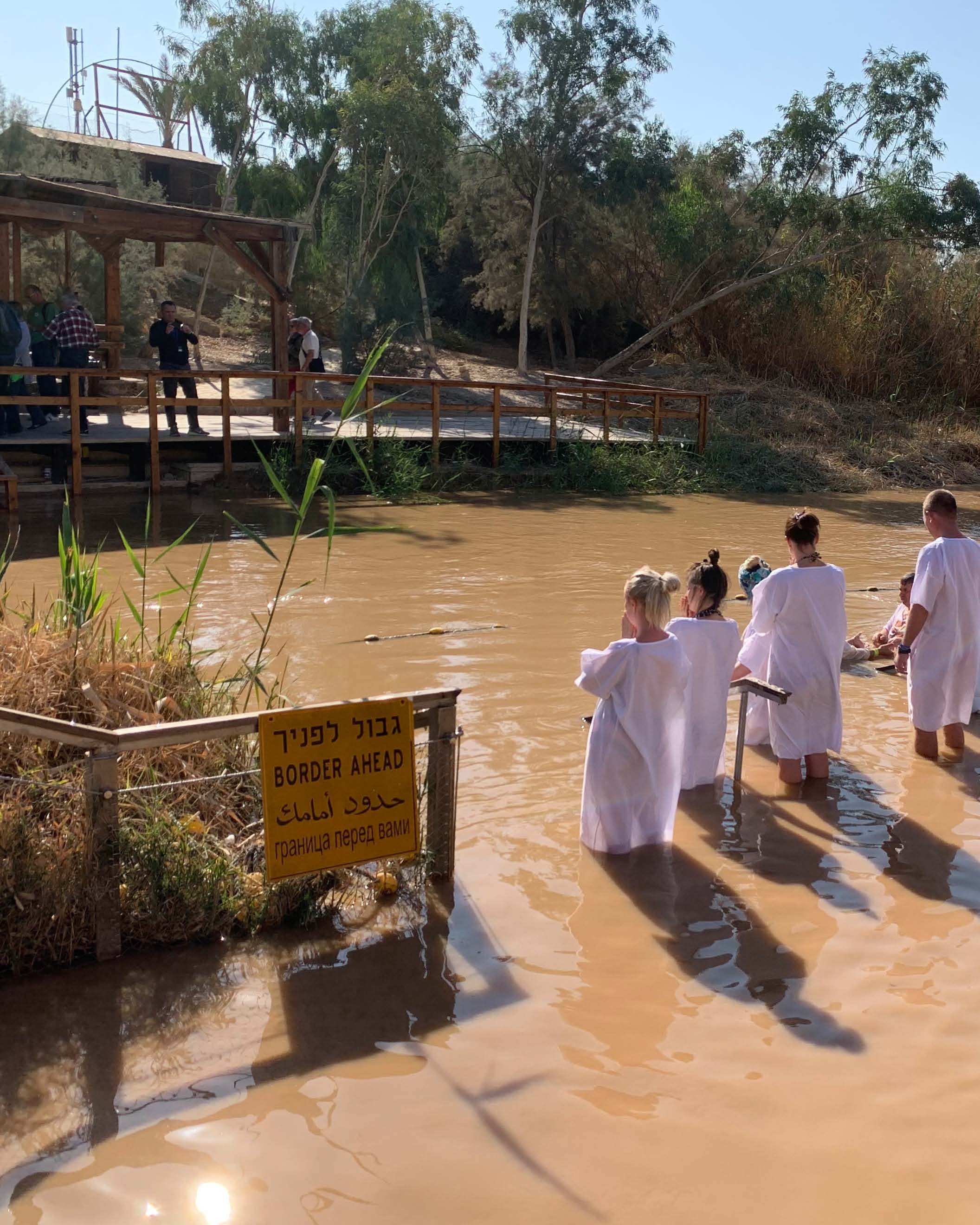 Christians taking baptism in the Jordan River (Source: Aaron Wolf, 2019).