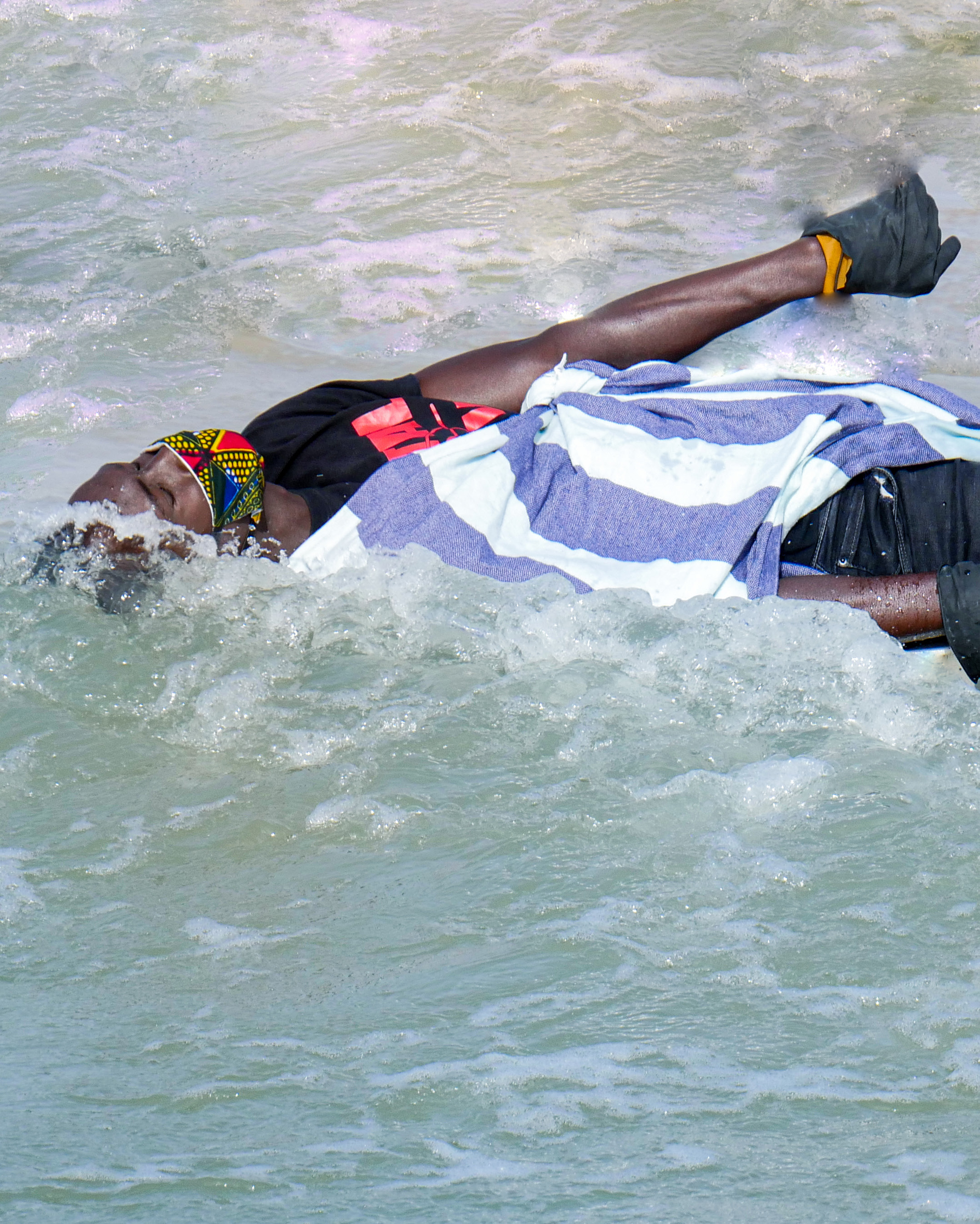 The person drowning in this Covid-19 exposition is metaphorical in depicting water as a source of death, conflict, war and tension (Source: Abdoulaye Touré, 2021, CC BY-NC-ND 4.0).